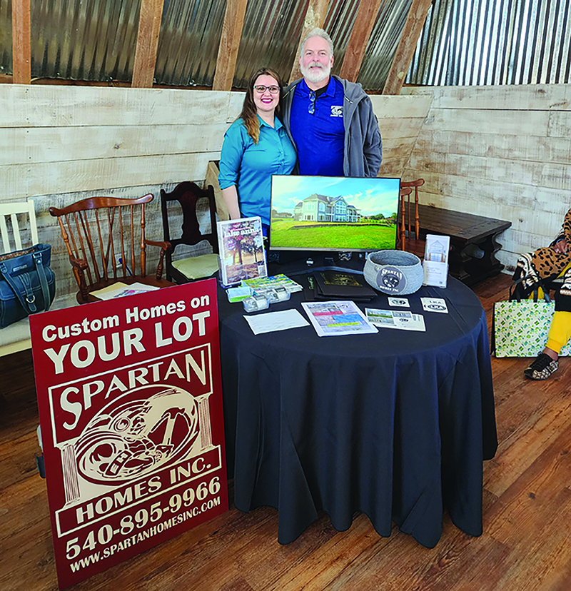 Krista Layman and her father, Eric Henry, showcase Spartan Homes at a realtor event. Henry is the president and owner of the company, and Layman is the office manager (submitted photo).