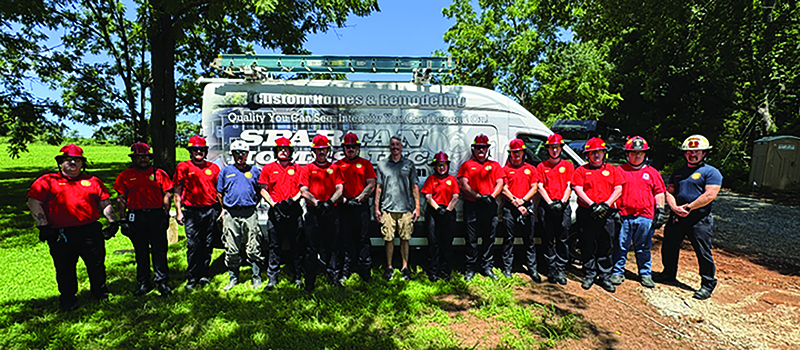 Krista Layman’s brother Mathew Henry is pictured with trainees for Spotsylvania Fire Stations 1 and 5. The trainees used one of Spartan’s recent constructions for training to see behind the drywall (submitted photo).
