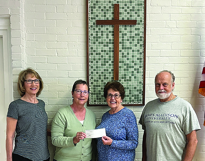 Members of the Louisa County Catholics Social Ministry (comprised of St Jude and Immaculate Conception Catholic church parishioners) recently gave a donation to the Louisa County Homeless Coalition. Pictured are Kathie Anastas and Ellen Casale handing a check to Lin Kogle and Duane Sergent (photo provided by Lin Kogle).<br />
